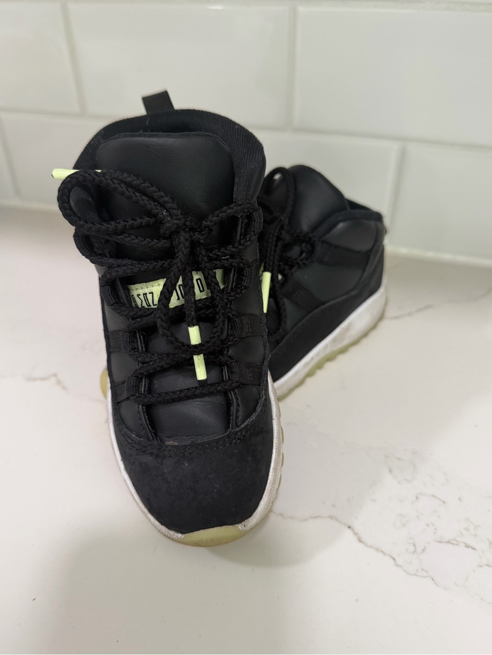 Kids Jordan’s Black High-Top Sneakers with Neon Accents